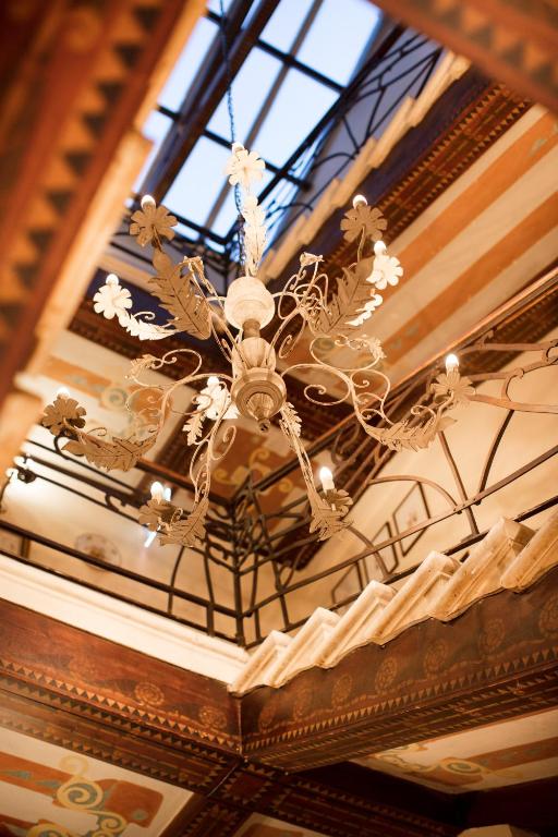 a chandelier hanging from a ceiling in a building at Hotel Flora in Venice