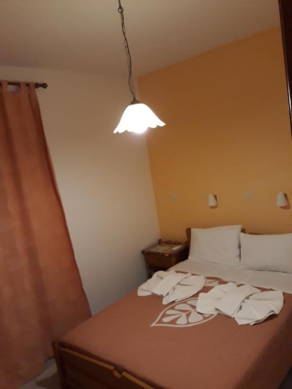 a bedroom with a bed with towels on it at Amaryllis Hotel in Karpathos