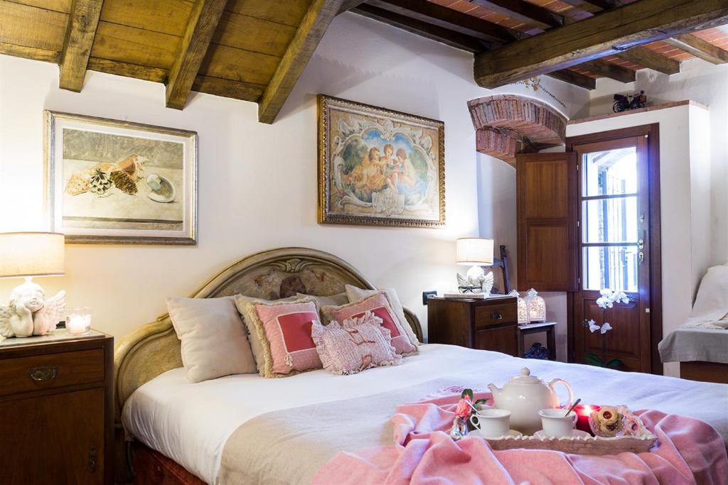 a bedroom with a bed with a tea set on it at Mulino del XVII secolo in Borgo a Buggiano