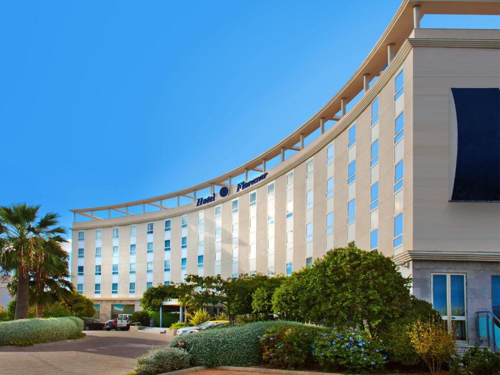 Un grand bâtiment blanc avec des personnes en haut dans l'établissement Flag Hotel Valencia Florazar, à Massalfassar