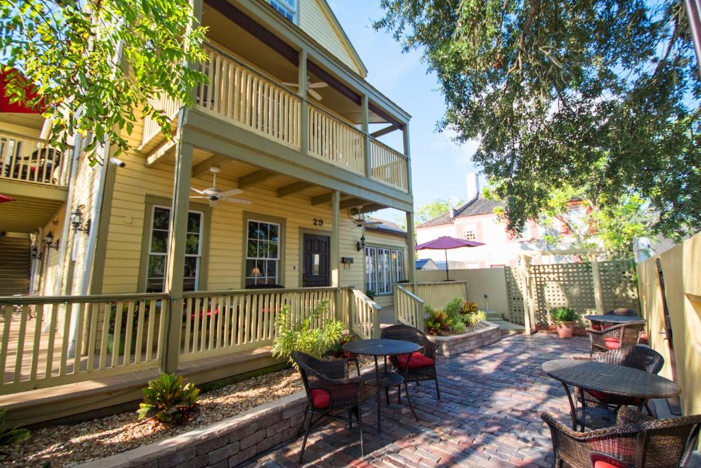 a patio with tables and chairs in front of a house at Agustin Inn - Saint Augustine - Adults Only in St. Augustine