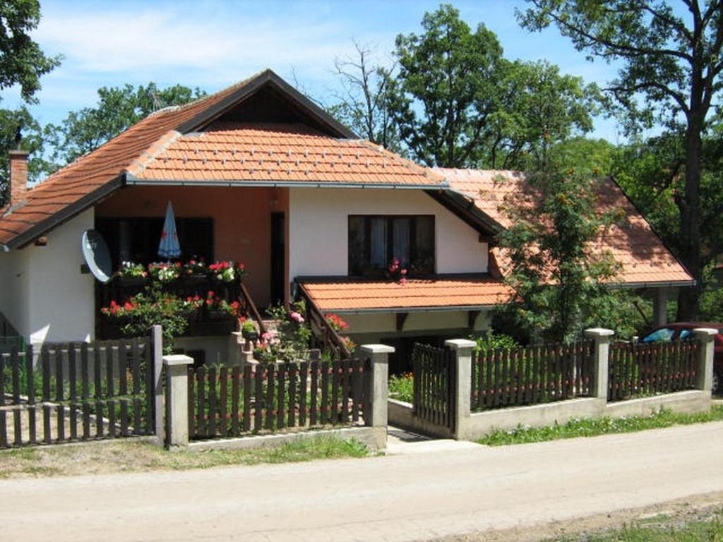 a small house with a fence in front of it at Apartments Zlatiborski Gajevi in Zlatibor