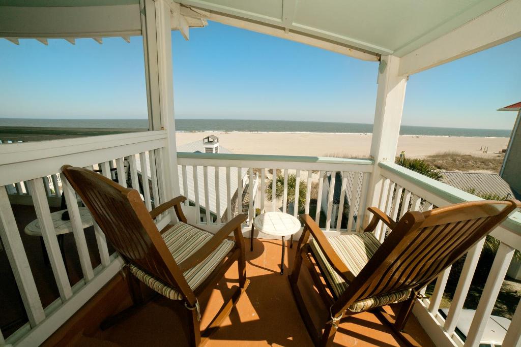 two chairs on a porch with a view of the beach at DeSoto Beach Terraces in Tybee Island