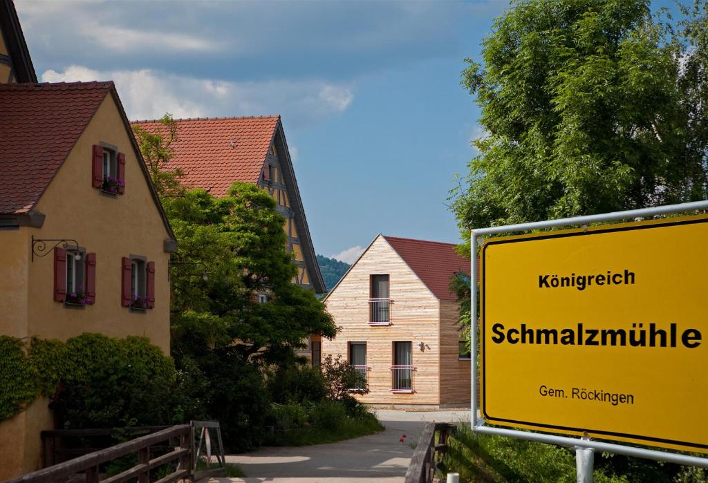 a yellow street sign in a town with houses at Erlebnis-Käse-Wohlfühl-Hof in Röckingen