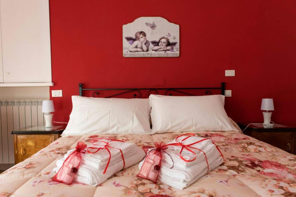 a bedroom with a bed with bows on it at B&B" del Castello" in Roccascalegna