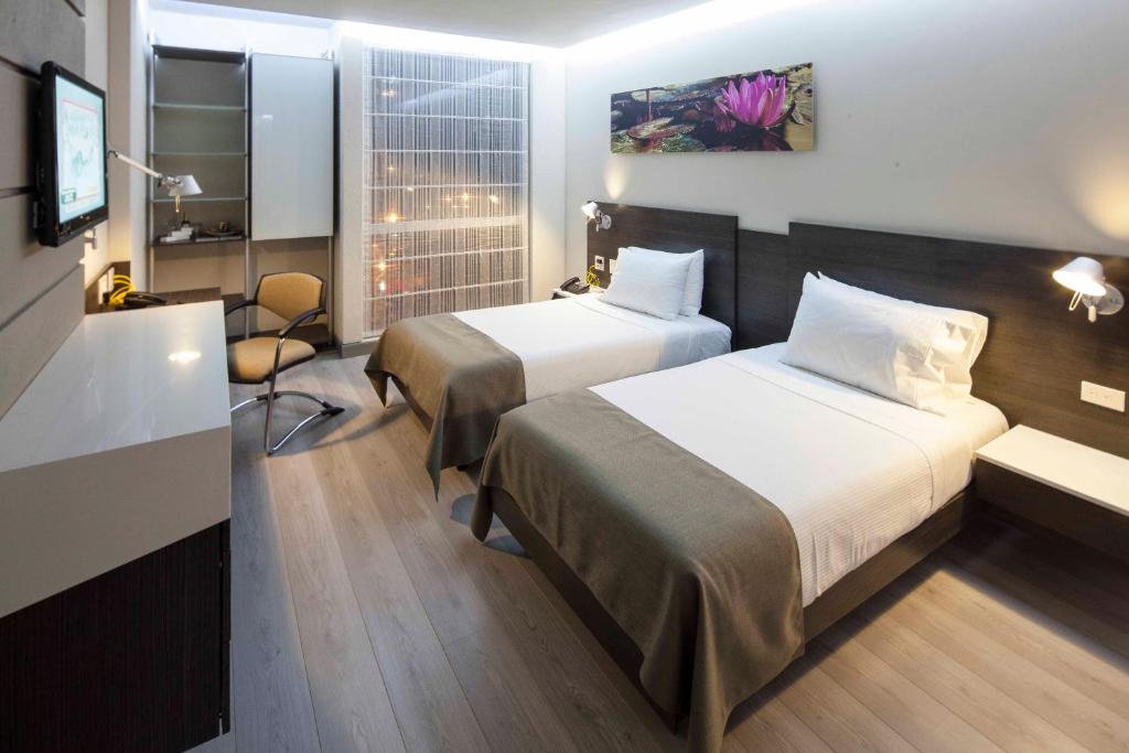 Postel nebo postele na pokoji v ubytování Inntu Hotel