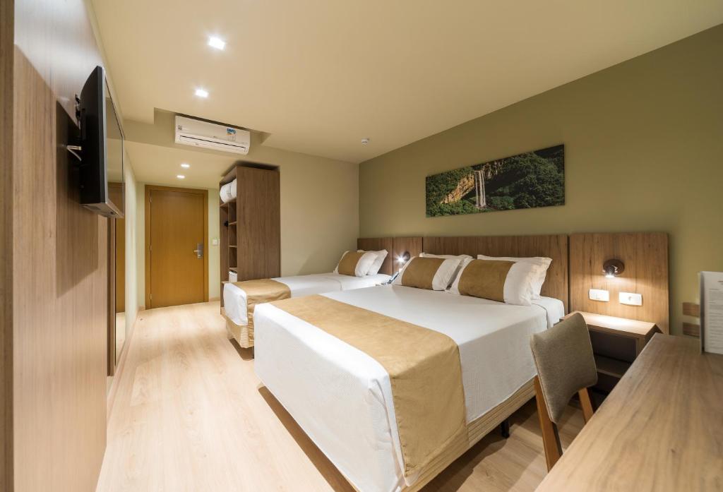 Postel nebo postele na pokoji v ubytování Hotel Laghetto Vivace