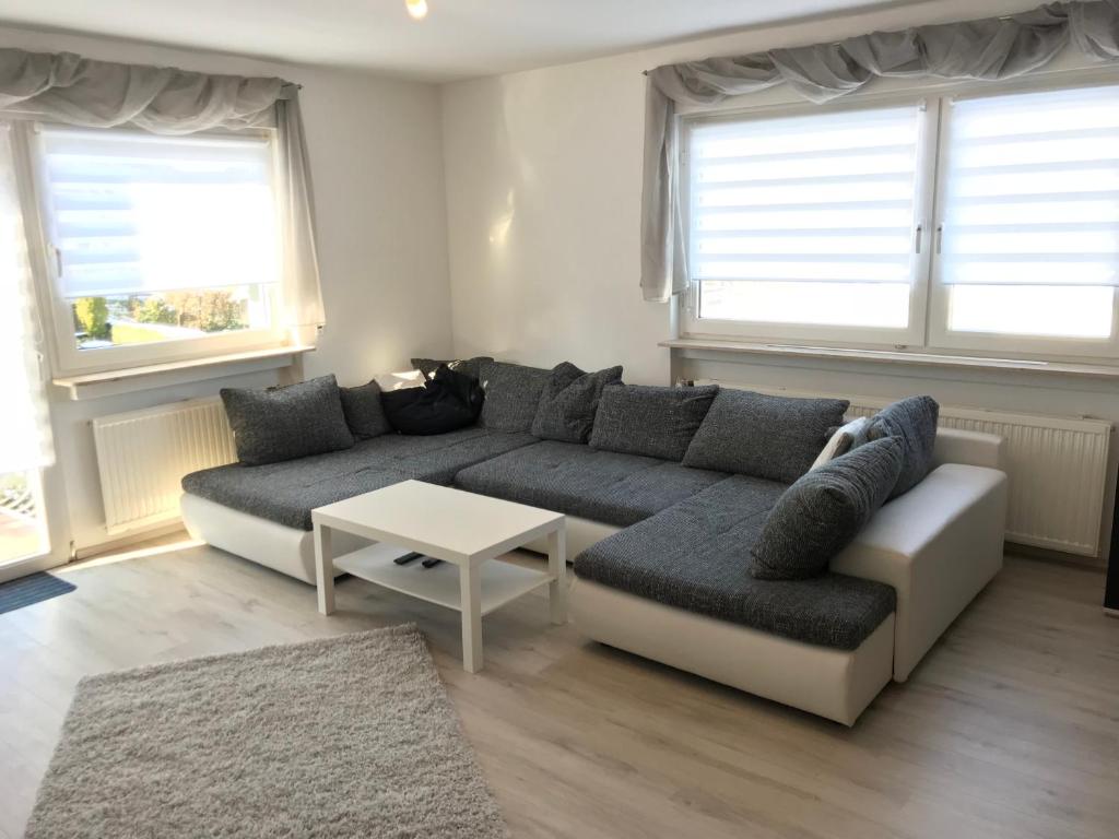 a living room with a couch and a table at Ferienwohnung Mittel-Gründau in Gründau