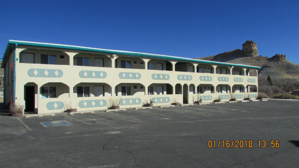 a large white building with a lot of windows at Western Inn - Green River in Green River
