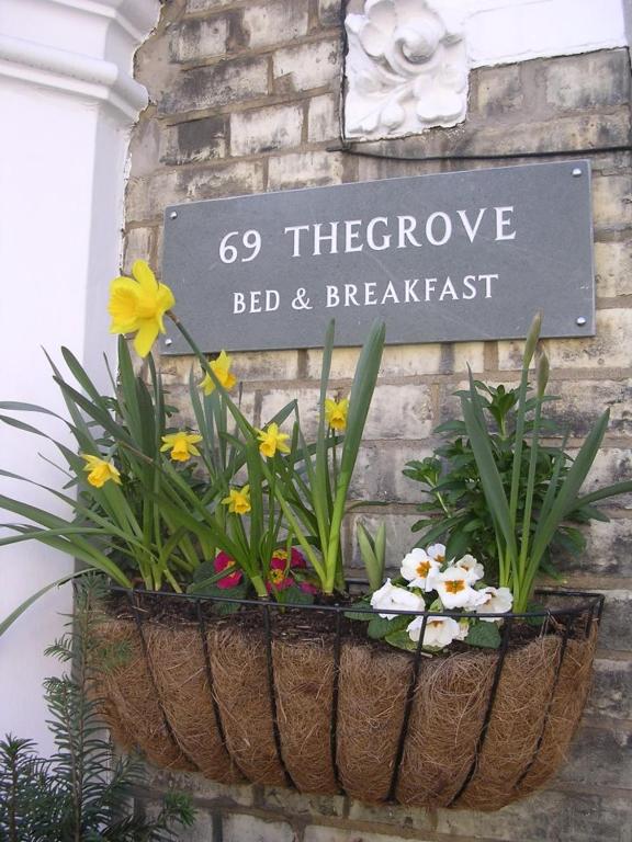 Hotel 69TheGrove, a sign that says go theourage bed and breakfast with flowers at 69TheGrove in London