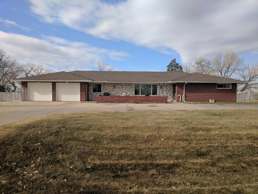 a house with a grass yard in front of it at DIA BnB - We love workers in Brighton