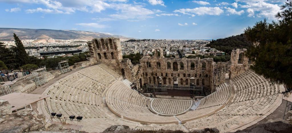 an empty amphitheater with a city in the background at Tranquil Central Apt, behind Athens Caravel Area in Athens