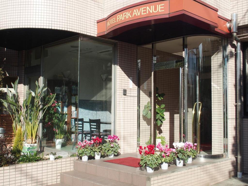 a store front with potted flowers in front of it at Hotel Park Avenue in Tokyo