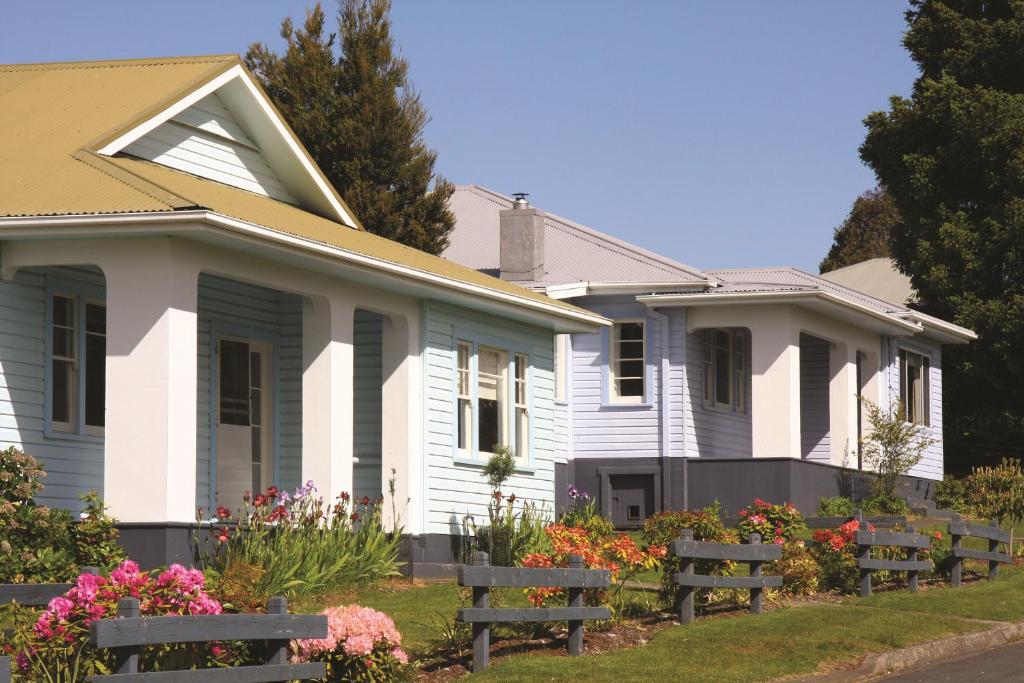 a house with benches in front of it at Tarraleah Estate in Tarraleah