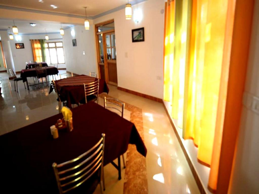 a dining room with a table and chairs in a room at Hotel Ladakh Heaven in Leh