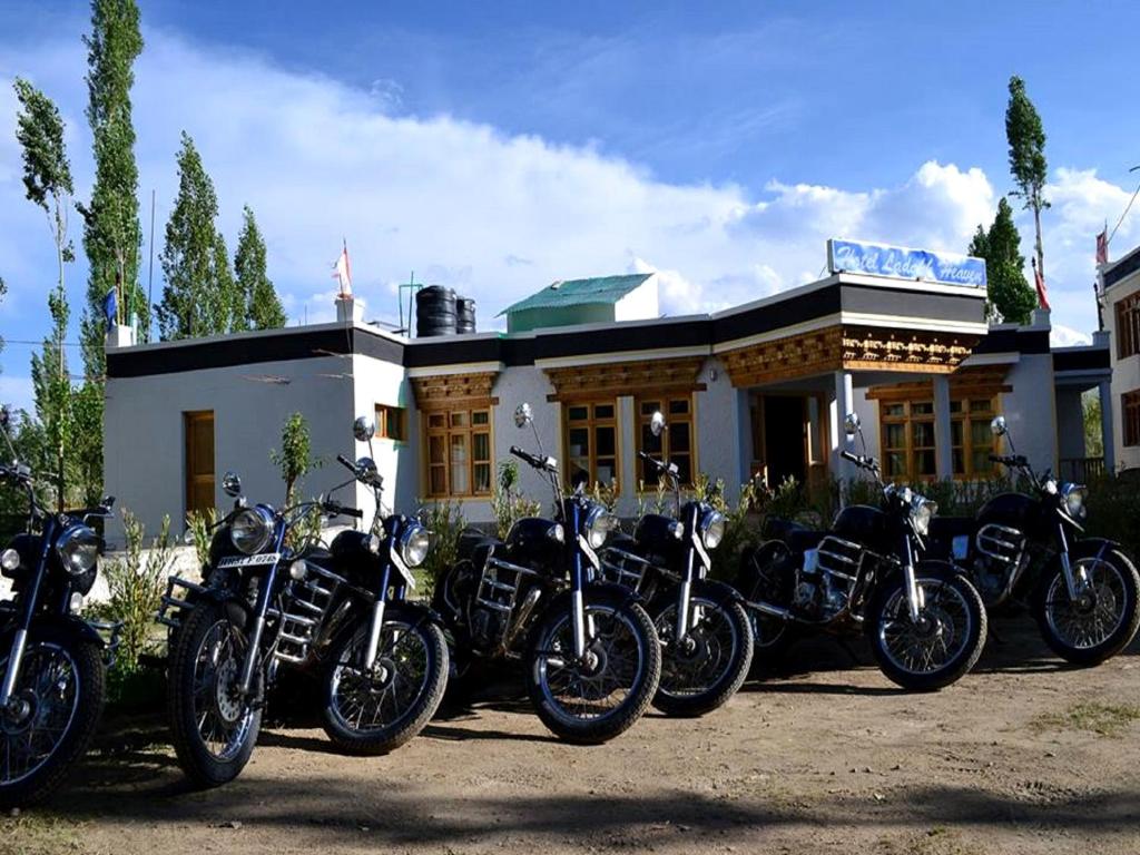 a row of motorcycles parked in front of a building at Hotel Ladakh Heaven in Leh