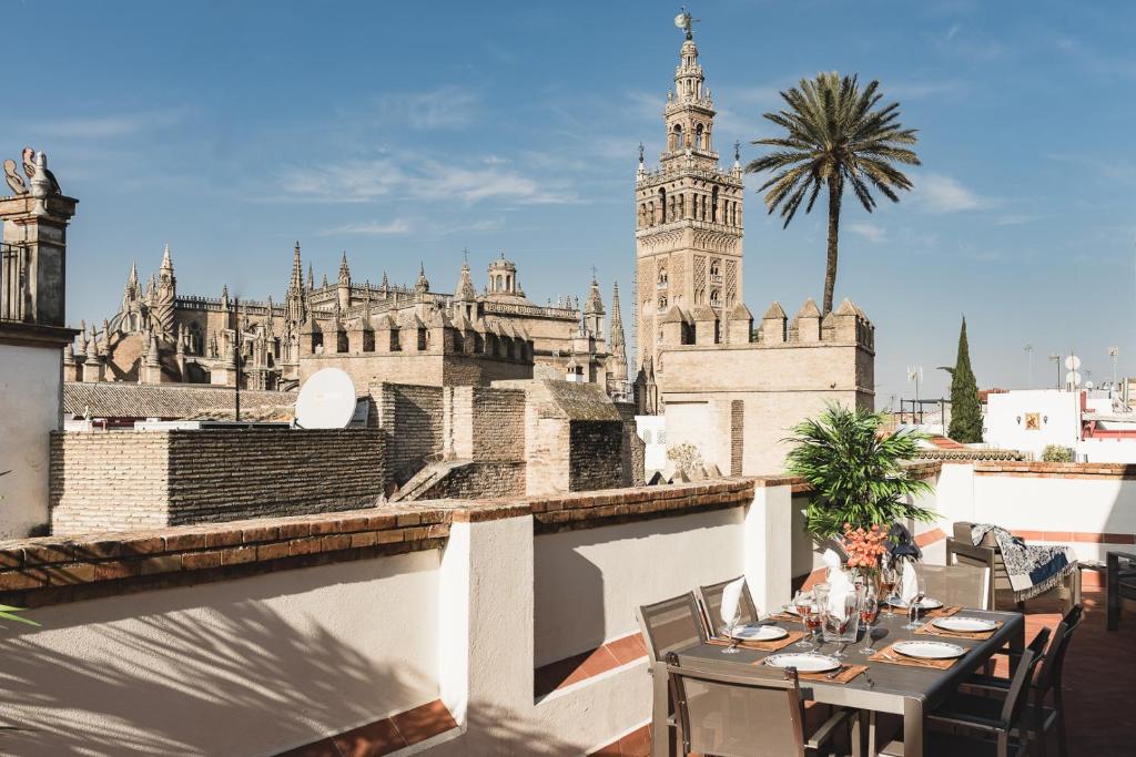 a table on a balcony with a view of a building at Puerta Principe Luxury Apartments in Seville
