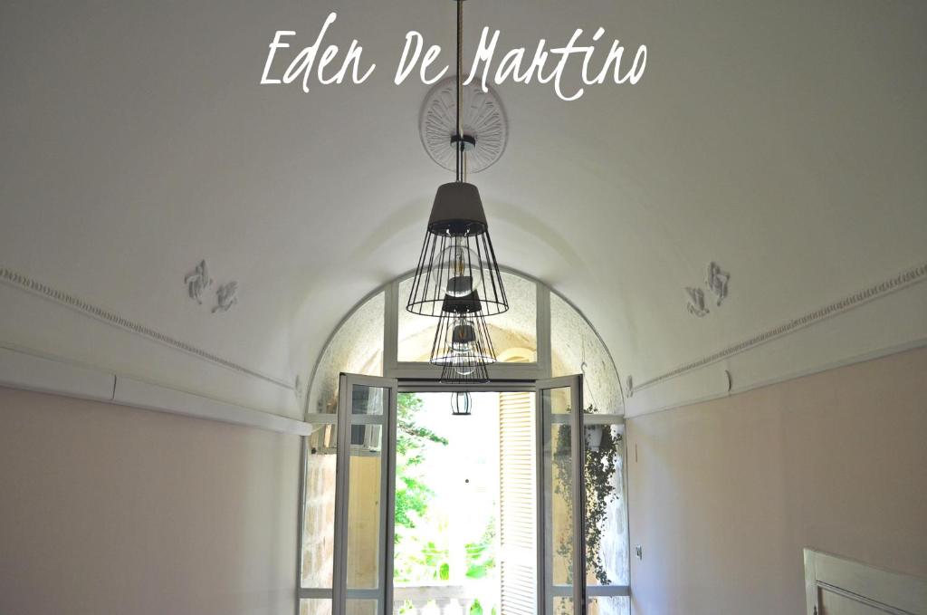 a chandelier hanging from a ceiling with the words eat be patient at Eden De Martino in Monopoli