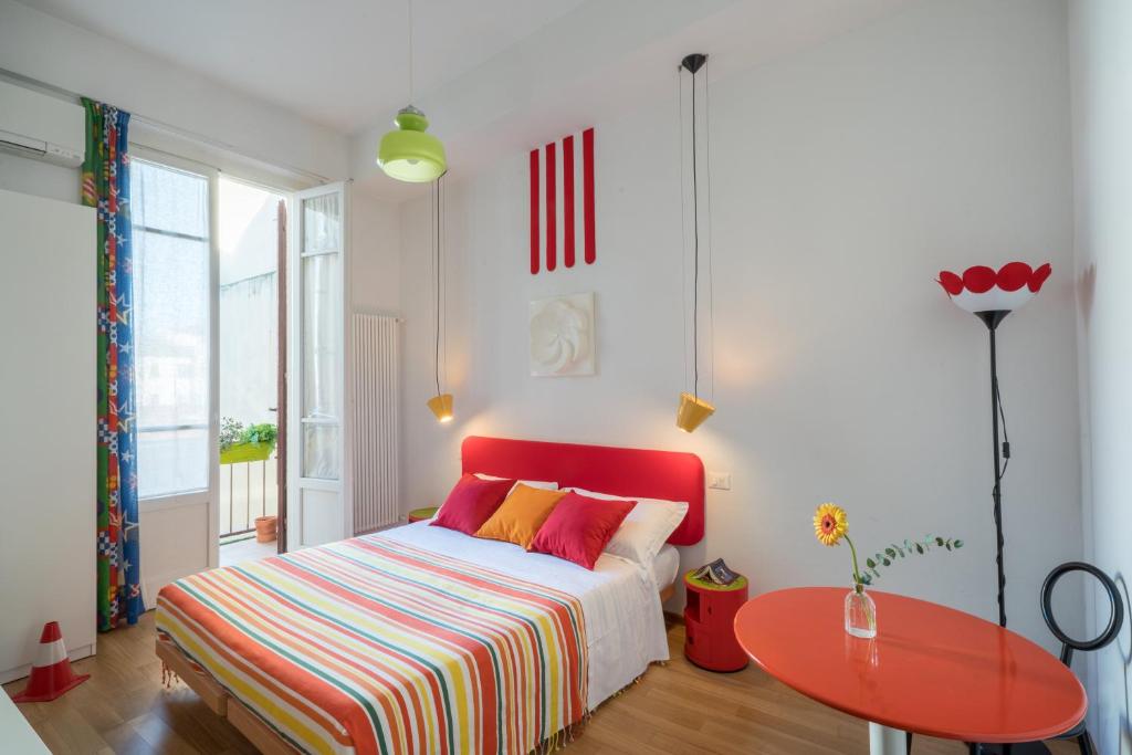 a bedroom with a red bed and a red table at Zip b&b . design in Florence in Florence