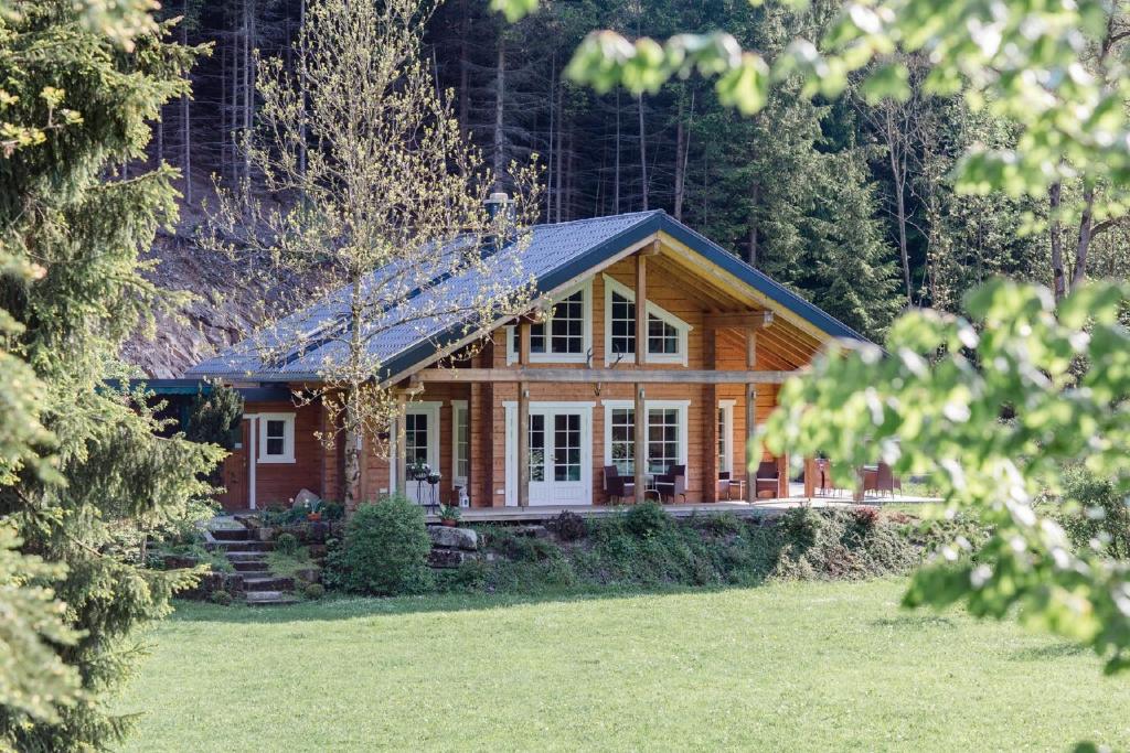 uma cabana de madeira na floresta com um quintal em Jagdhaus zur Bischofsmühle em Helmbrechts