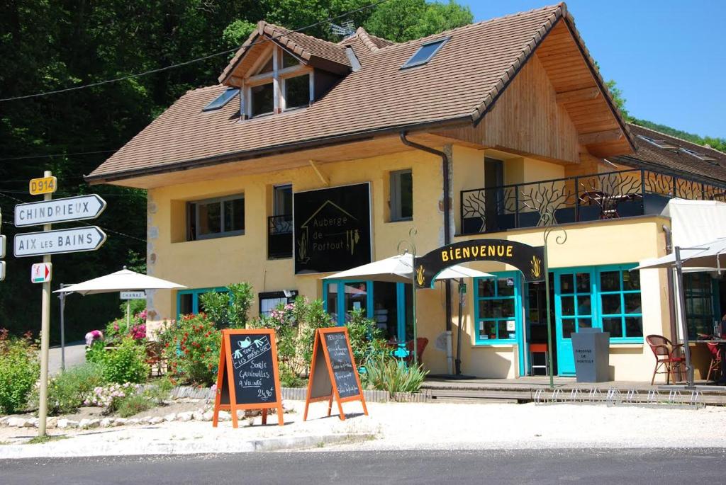 a building with a sign in front of it at Auberge de Portout in Chanaz