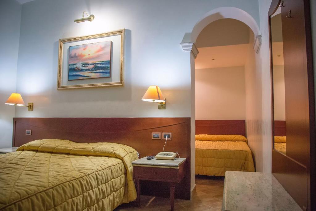 Postel nebo postele na pokoji v ubytování Palmed Hotel