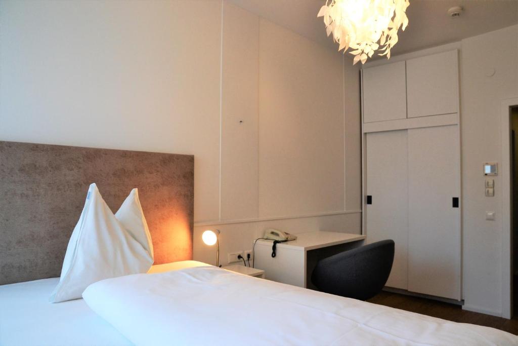Postel nebo postele na pokoji v ubytování Hotel Hecher