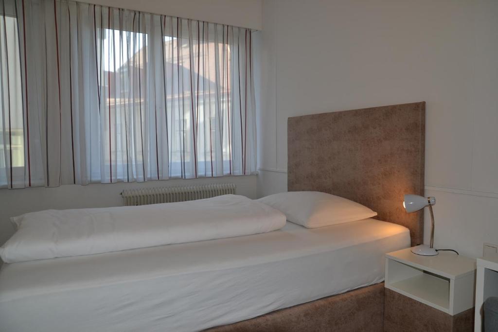 Postel nebo postele na pokoji v ubytování Hotel Hecher