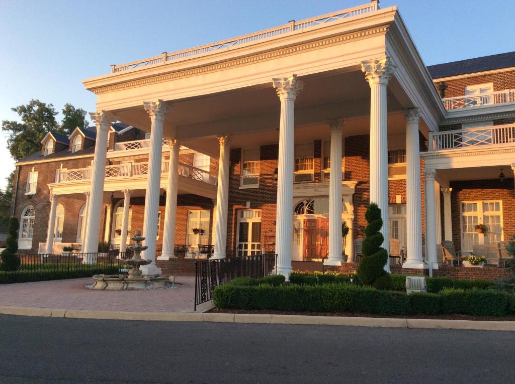 a large white building with columns at The Mimslyn Inn in Luray