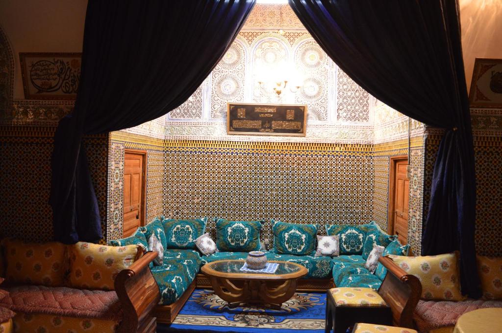 a living room with a couch and a table at Chez L'habitant Boueden in F&egrave;s