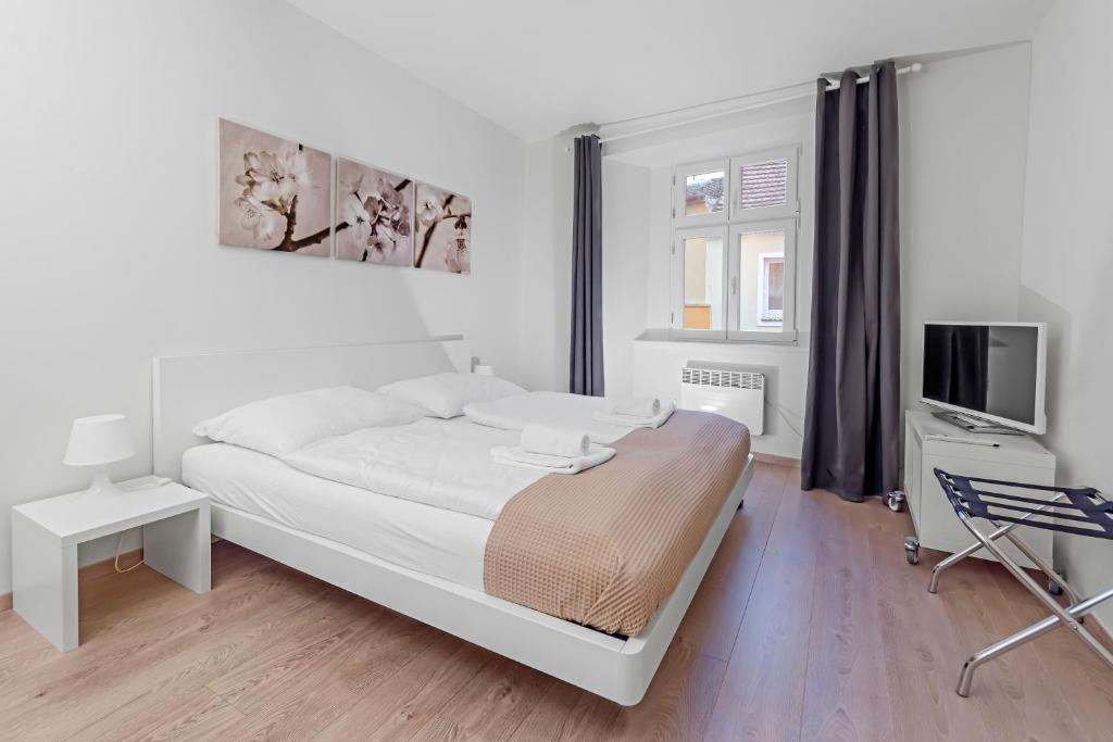 Postel nebo postele na pokoji v ubytování TGM Hotel Residence