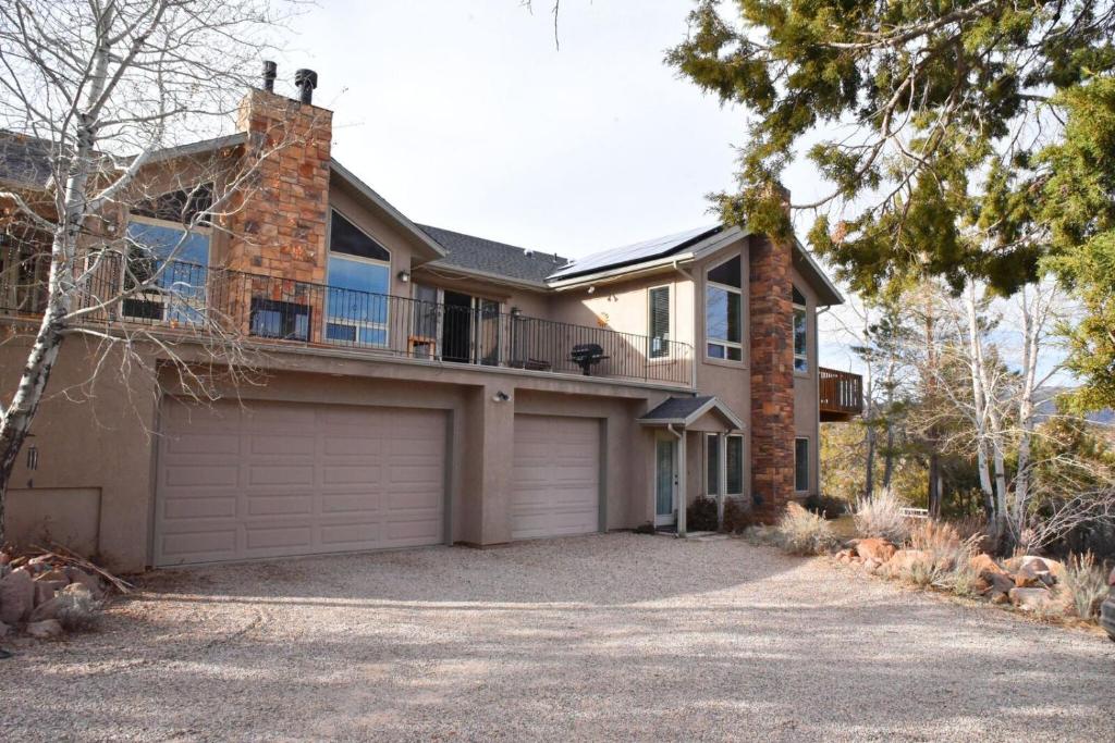 a house with a garage in front of it at Harmony Belle at Kolob Canyon in New Harmony