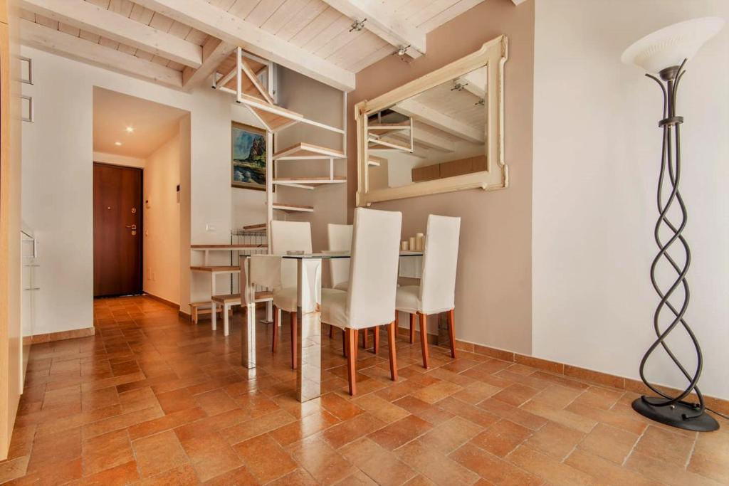 a dining room with a table and chairs and a loft at Penthouse Luxury Quattro Canti in Palermo