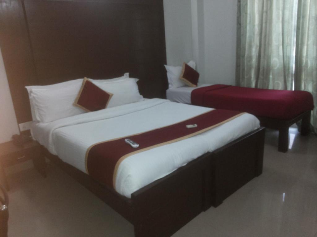 Postel nebo postele na pokoji v ubytování Orion Residency Hotel Near Chennai Central Railway Station