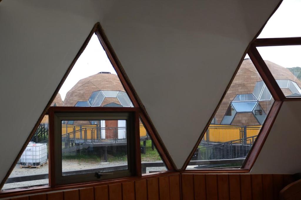 a group of windows in a room with a building at Chiloe Domos Curaco de Vélez in Curaco de Velez