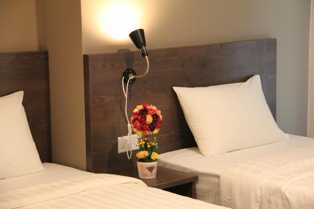 Postel nebo postele na pokoji v ubytování KL Hotel