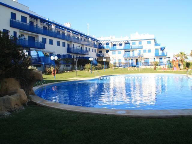 a large swimming pool in front of a building at Apartamentos Marineu San Damian Playa Cargador in Alcossebre