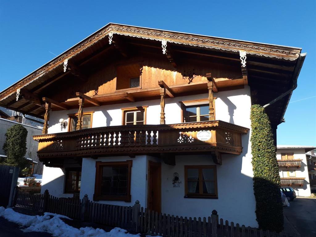 a house with a balcony on top of it at Ferienhäusl Hubert und Staller in Kaltenbach