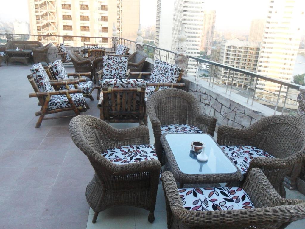 a group of chairs and tables on a balcony at EL Tonsy Hotel in Cairo