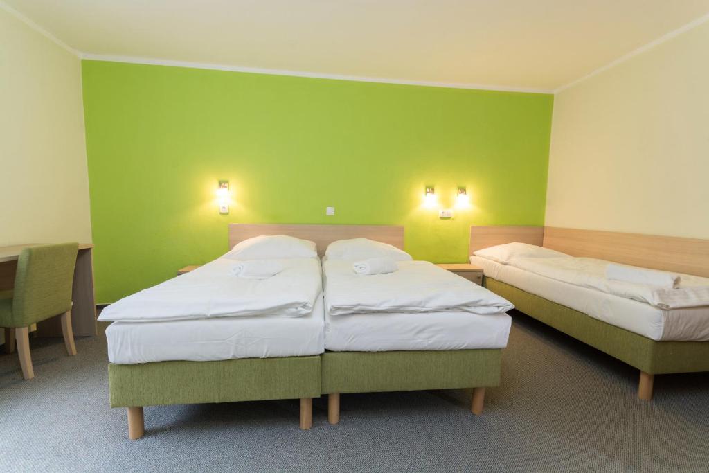 Postel nebo postele na pokoji v ubytování Hotel Na Kocandě
