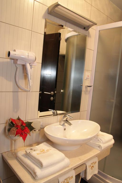 a bathroom with a sink and a mirror and towels at Hotel Royal Spa in Banja Koviljača