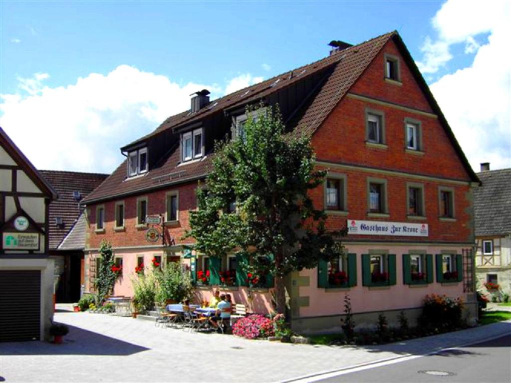 un edificio con un árbol delante de él en Gasthaus Zur Krone, en Windelsbach