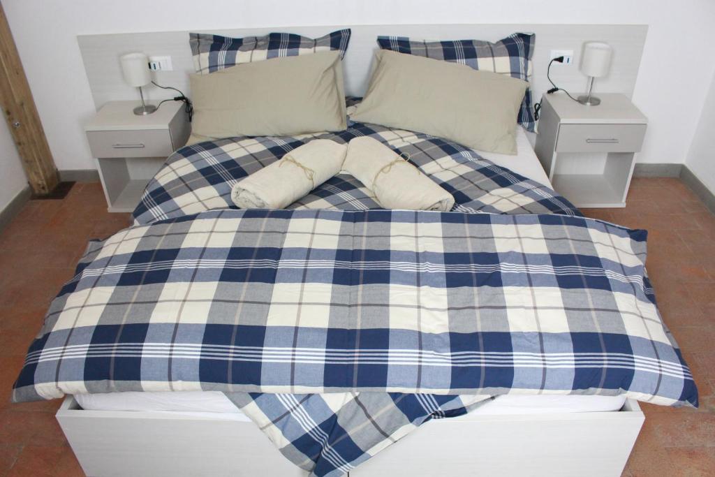 a blue and white bed with pillows on it at Affittacamere Cipri in Montale