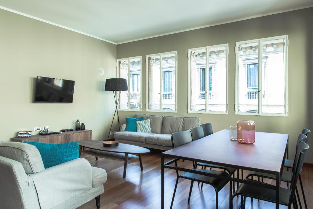 a living room with a couch and a table at Brera Apartments in San Marco in Milan