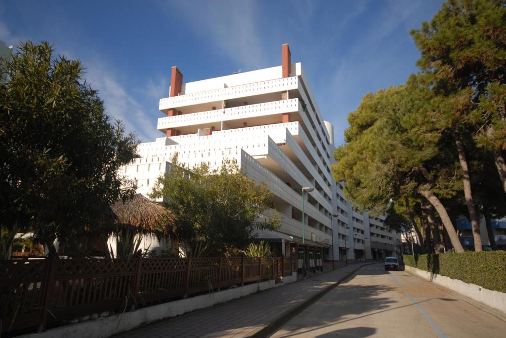 a large white building on the side of a street at Appartamenti Luna in Lignano Sabbiadoro