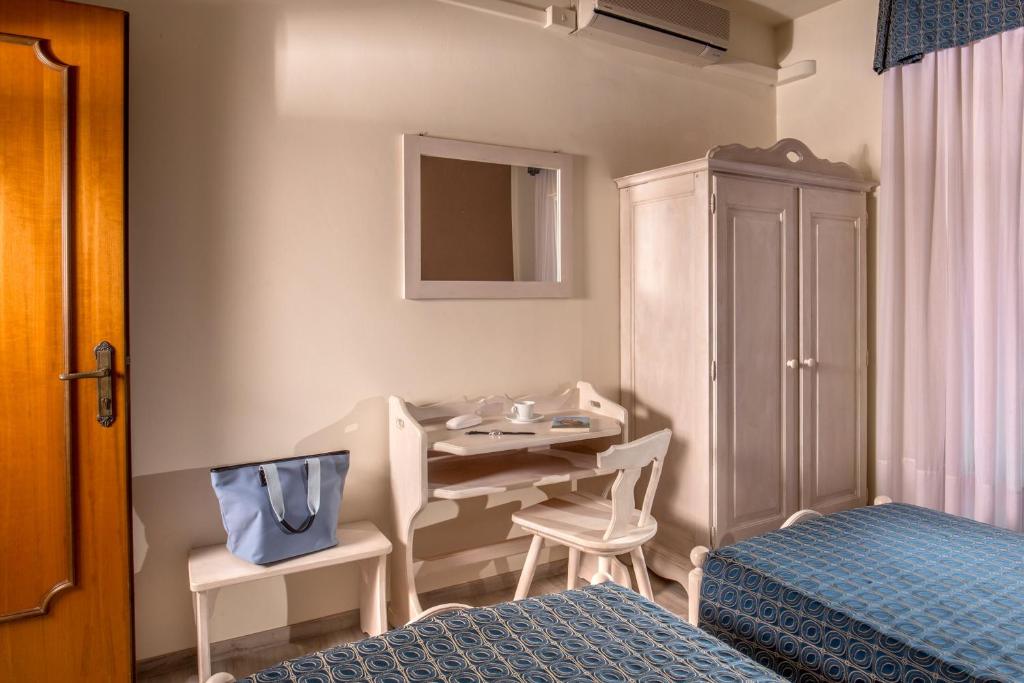 Postel nebo postele na pokoji v ubytování Hotel Corallo
