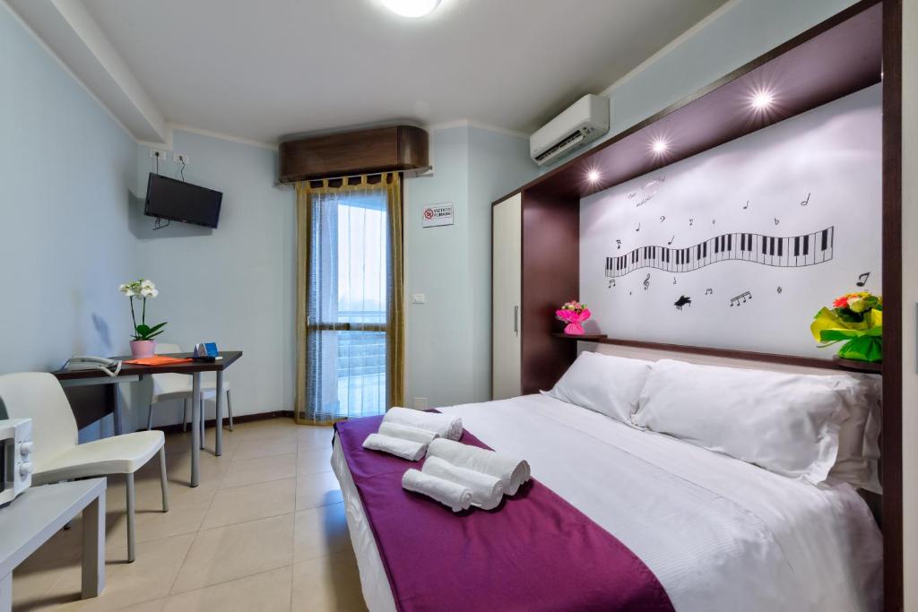 Łóżko lub łóżka w pokoju w obiekcie AppartaHotel
