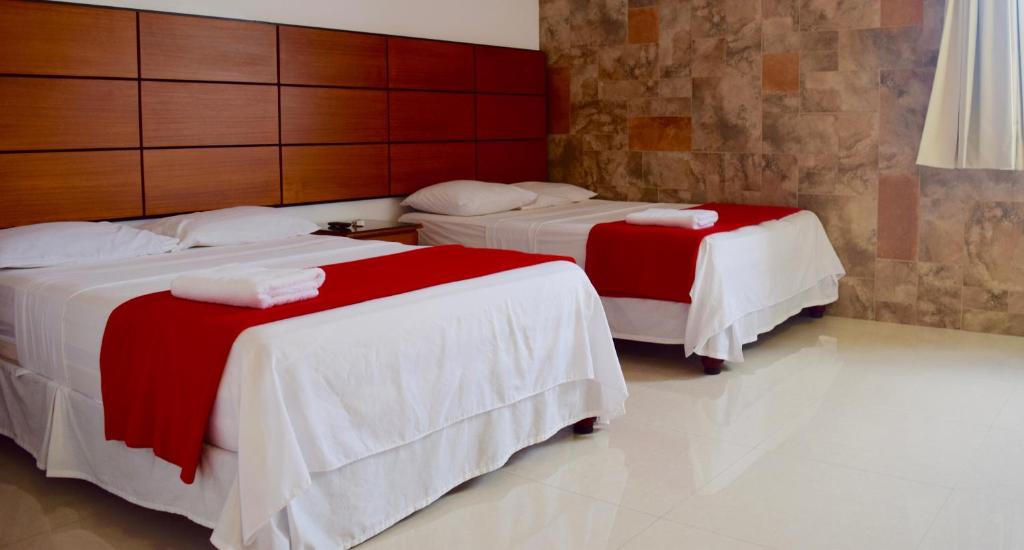 Postel nebo postele na pokoji v ubytování Hotel Apart Guayaquil Aeropuerto