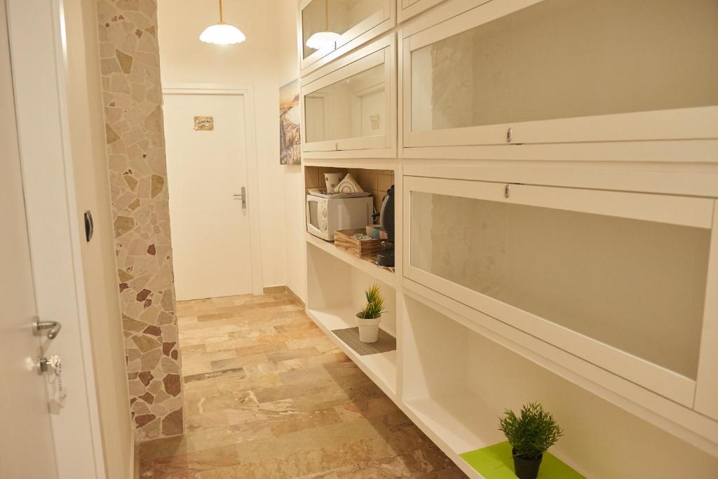 a hallway with a walk in pantry with plants in it at L'Anfiteatro di Pompei B&B in Pompei