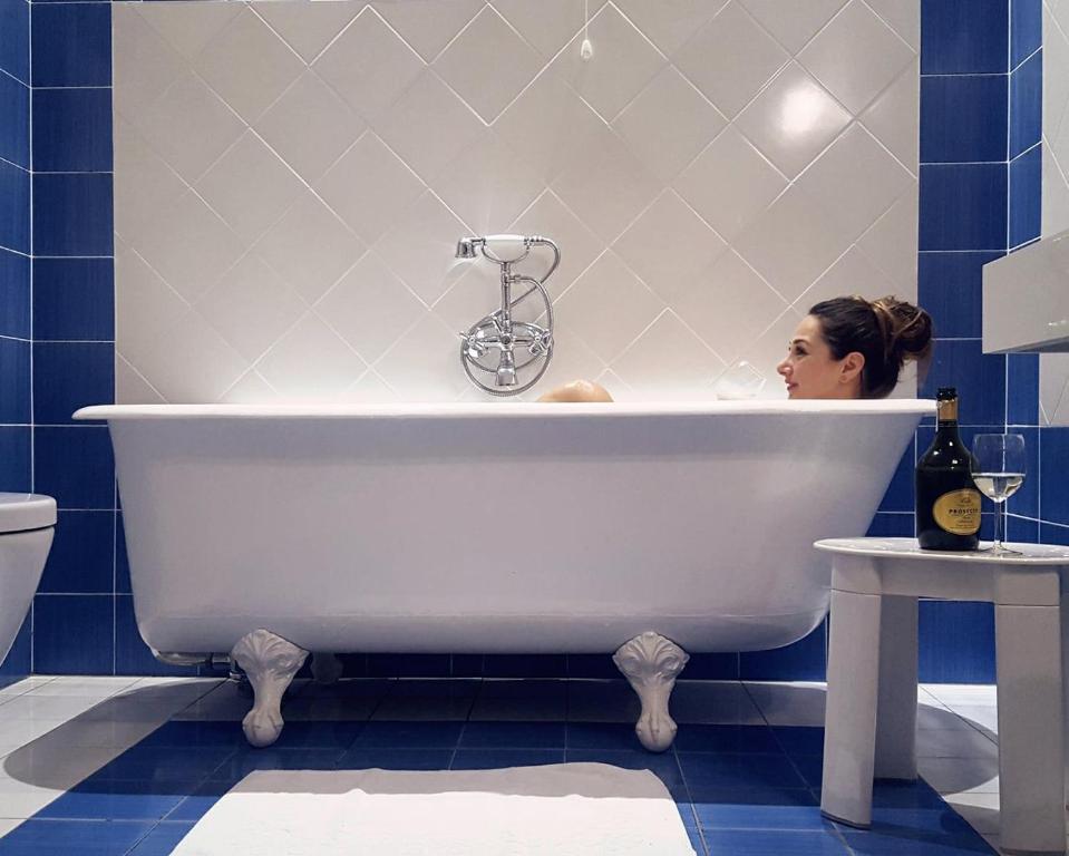 
a white bath tub sitting next to a white toilet at Residenza d'Epoca Palazzo Riblet in Florence
